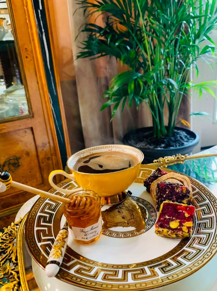 Coffee and pastries served on gold-rimmed china